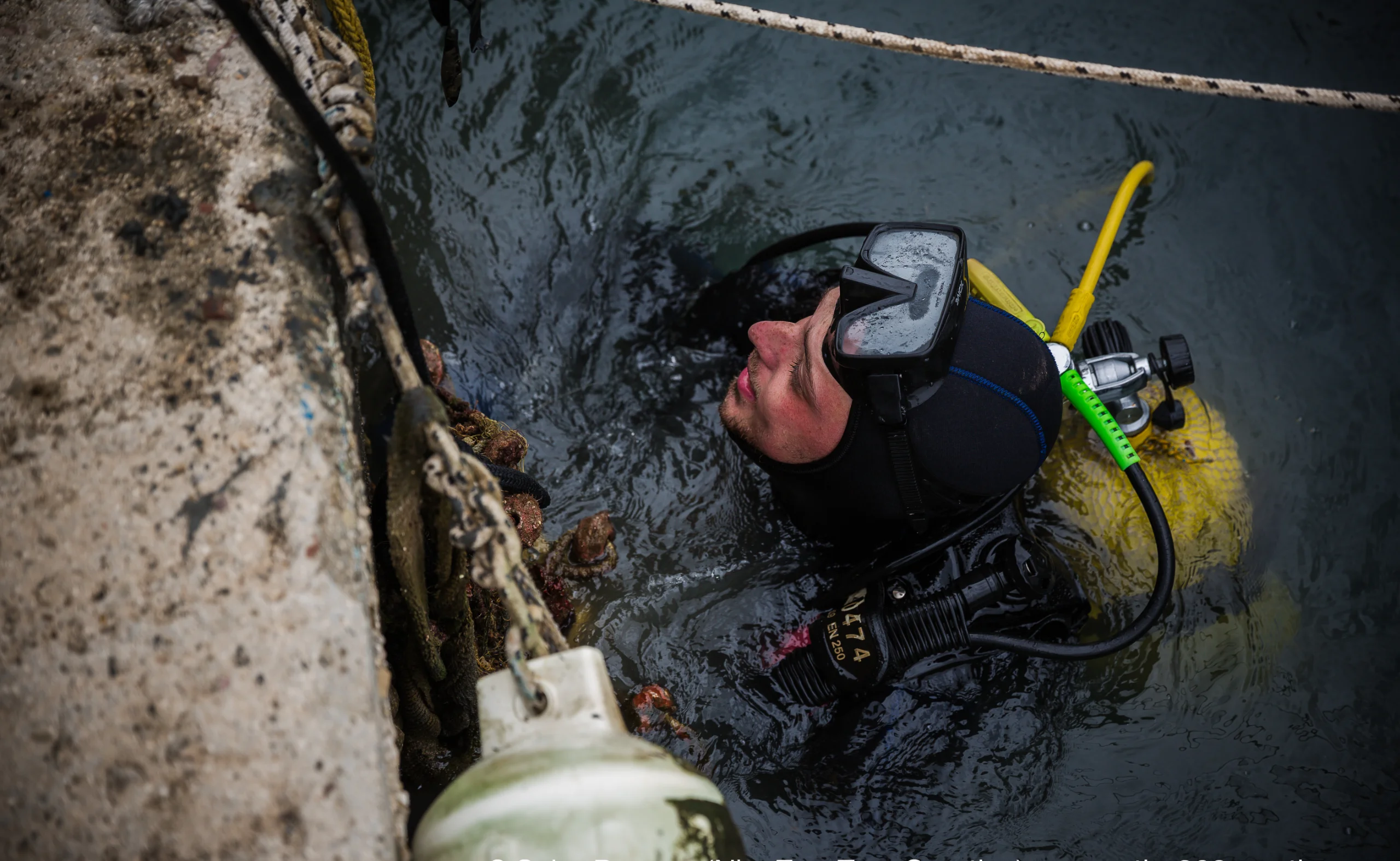 A scuba diver participating in an underwater cleanup effort.